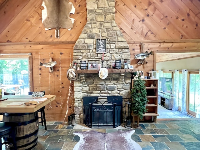 6774 S Becks Grove Rd, Freetown, IN 47235 - living room with lofted ceiling, stone tile flooring, healthy amount of natural light, wooden walls, and wood ceiling