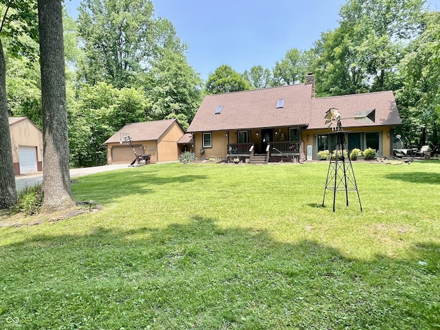 6774 S Becks Grove Rd, Freetown, IN 47235 - back of house with a porch, an outdoor structure, a garage, a lawn, and roof with shingles