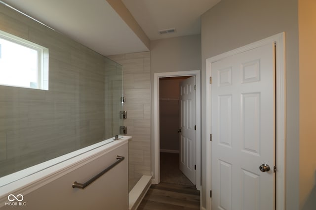 4250 Ironclad Dr, Bargersville, IN 46106 - bathroom with a tile shower, wood finished floors, and a spacious closet