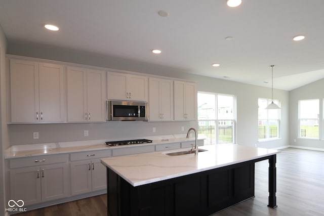 4250 Ironclad Dr, Bargersville, IN 46106 - kitchen with stainless steel microwave, dark wood-type flooring, recessed lighting, decorative light fixtures, and gas cooktop