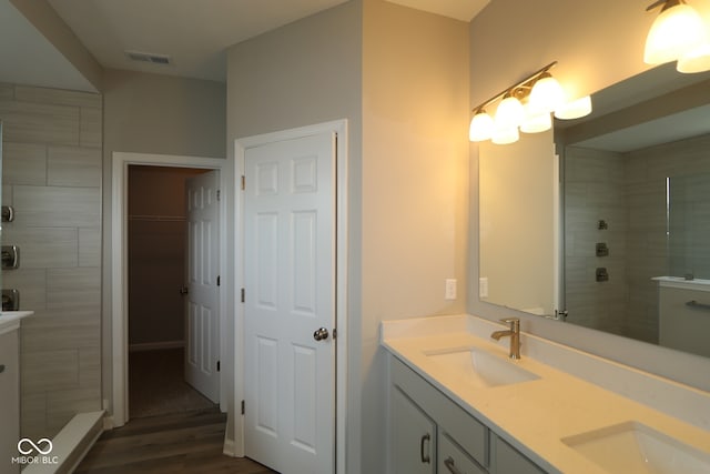 4250 Ironclad Dr, Bargersville, IN 46106 - full bath with double vanity, wood finished floors, tiled shower, and a walk in closet
