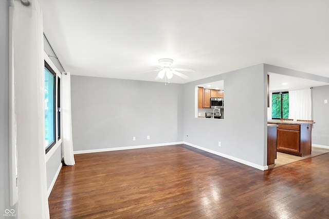 3126 Carriage Rd, West Lafayette, IN 47906 - unfurnished living room featuring wood finished floors, ceiling fan, and baseboards