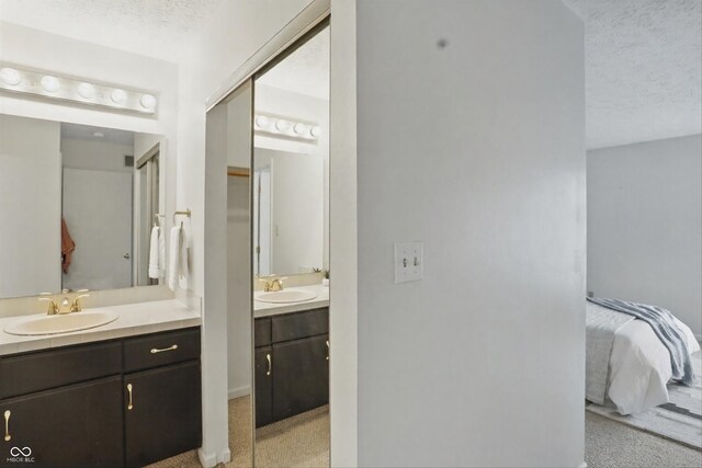 7510 Harbour, Indianapolis, IN 46240 - ensuite bathroom featuring two vanities and a textured ceiling