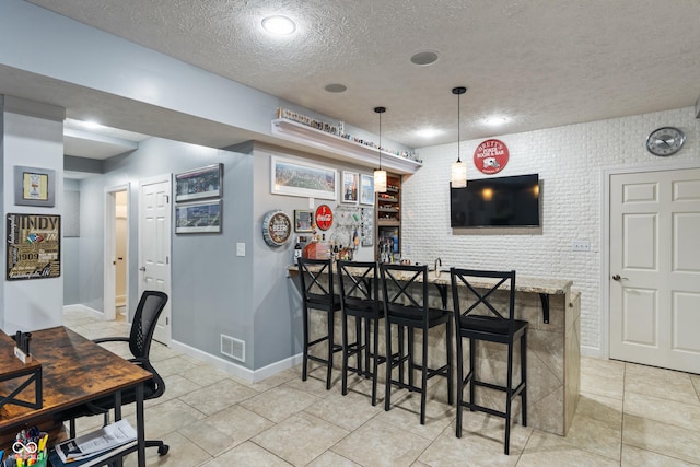 9756 Brook Meadow Dr, Mccordsville, IN 46055 - indoor dry bar featuring a textured ceiling, baseboards, hanging light fixtures, and light tile patterned flooring