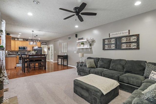 9756 Brook Meadow Dr, Mccordsville, IN 46055 - living area with ceiling fan, recessed lighting, dark colored carpet, a textured ceiling, and baseboards