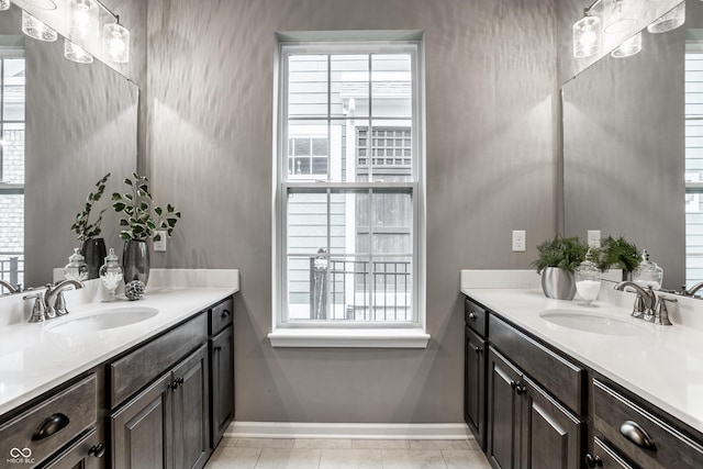 15596 Edenvale Dr, Westfield, IN 46074 - full bathroom with baseboards, two vanities, and healthy amount of natural light