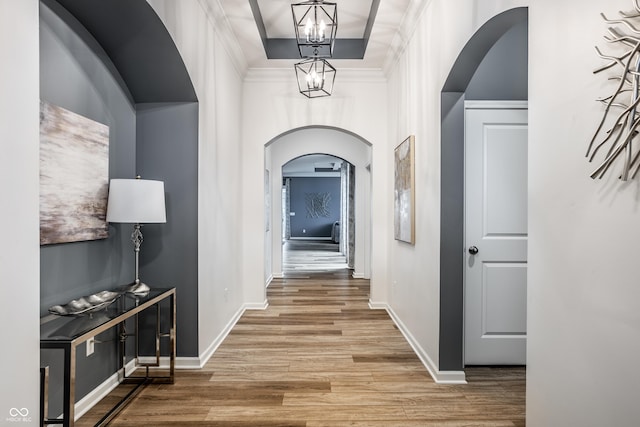 15596 Edenvale Dr, Westfield, IN 46074 - hall with arched walkways, wood finished floors, a chandelier, and baseboards