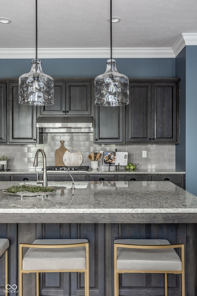 15596 Edenvale Dr, Westfield, IN 46074 - kitchen featuring decorative backsplash, crown molding, light stone countertops, and pendant lighting