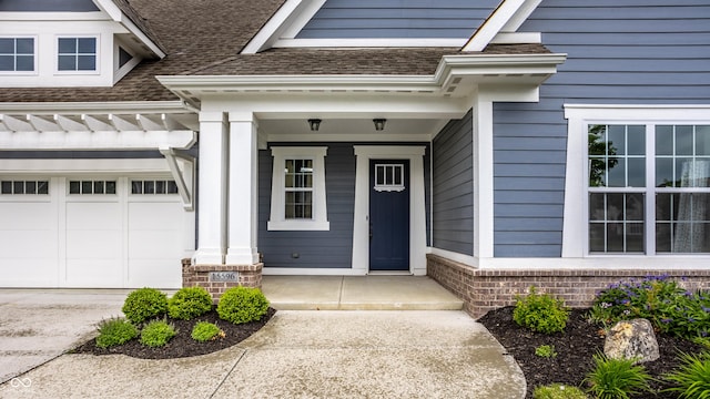 15596 Edenvale Dr, Westfield, IN 46074 - doorway to property with roof with shingles, covered porch, and concrete driveway