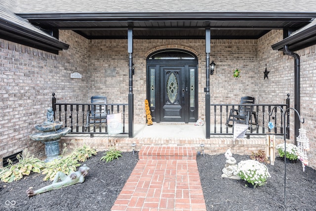 28 Patriot Ct, Greenfield, IN 46140 - entrance to property with covered porch, brick siding, and roof with shingles