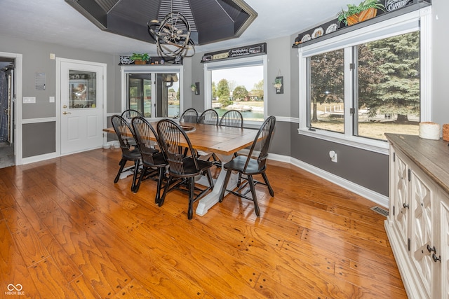 28 Patriot Ct, Greenfield, IN 46140 - dining area featuring light wood finished floors, baseboards, and a chandelier
