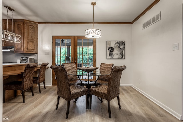 8905 Washington Blvd W Drive, Indianapolis, IN 46240 - dining area with french doors, light wood-type flooring, baseboards, and crown molding