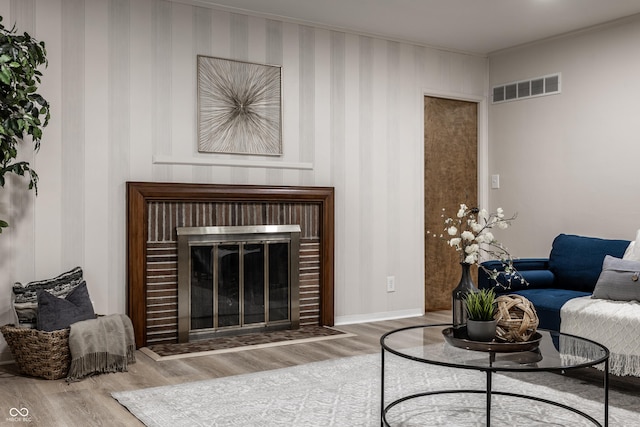 8905 Washington Blvd W Drive, Indianapolis, IN 46240 - living area featuring wood finished floors, a glass covered fireplace, baseboards, and ornamental molding