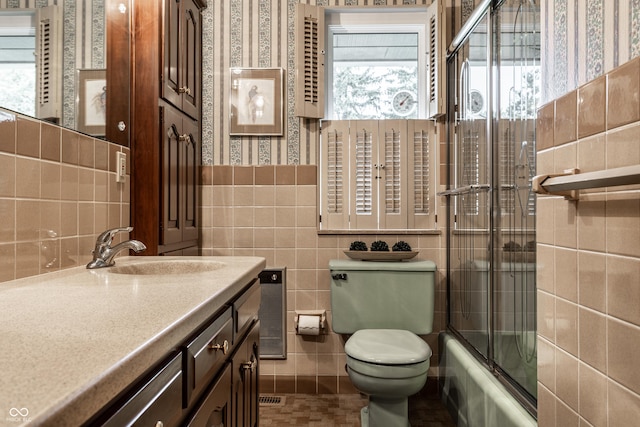 8905 Washington Blvd W Drive, Indianapolis, IN 46240 - bathroom with tile walls, toilet, wallpapered walls, vanity, and enclosed tub / shower combo