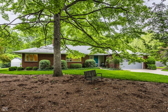 8905 Washington Blvd W Drive, Indianapolis, IN 46240 - single story home with driveway, brick siding, a garage, and a front yard