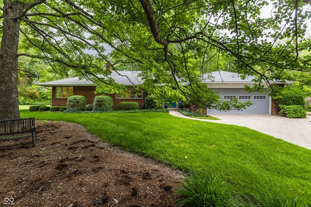 8905 Washington Blvd W Drive, Indianapolis, IN 46240 - view of grassy yard featuring driveway and a garage