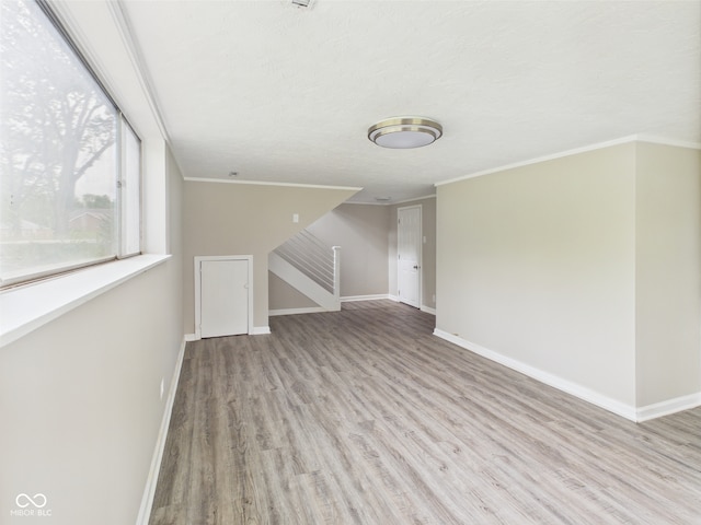 1325 Northcrest Dr, Anderson, IN 46012 - unfurnished living room with wood finished floors, baseboards, and crown molding