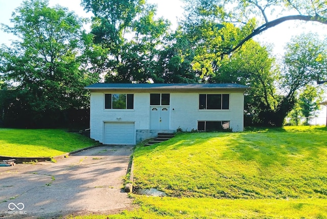 1325 Northcrest Dr, Anderson, IN 46012 - raised ranch featuring concrete driveway, an attached garage, and a front yard