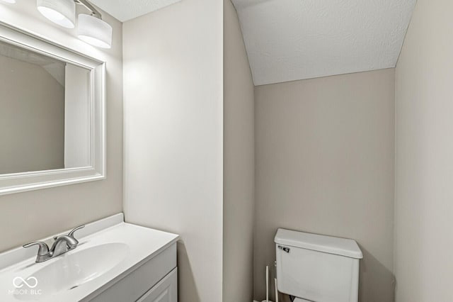 11072 Lake Run Dr, Fishers, IN 46038 - half bathroom featuring toilet, vanity, and a textured ceiling
