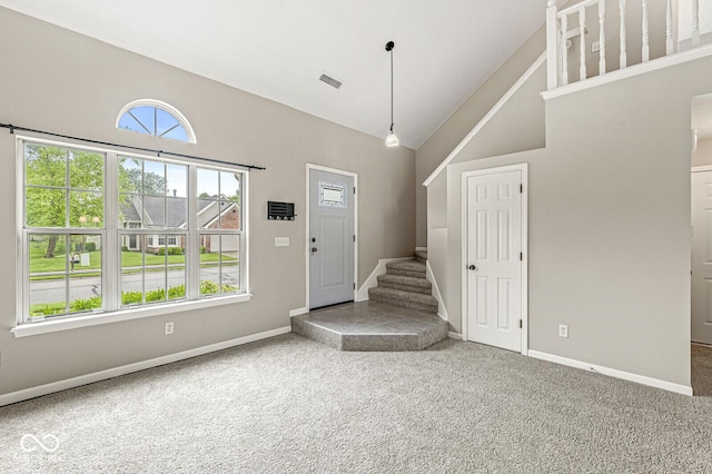 11072 Lake Run Dr, Fishers, IN 46038 - carpeted entryway featuring baseboards, stairway, and high vaulted ceiling
