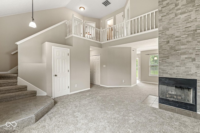11072 Lake Run Dr, Fishers, IN 46038 - unfurnished living room with carpet floors, stairs, high vaulted ceiling, a fireplace, and baseboards