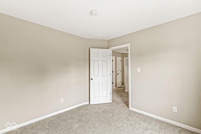 11072 Lake Run Dr, Fishers, IN 46038 - empty room with a smoke detector, carpet, and baseboards