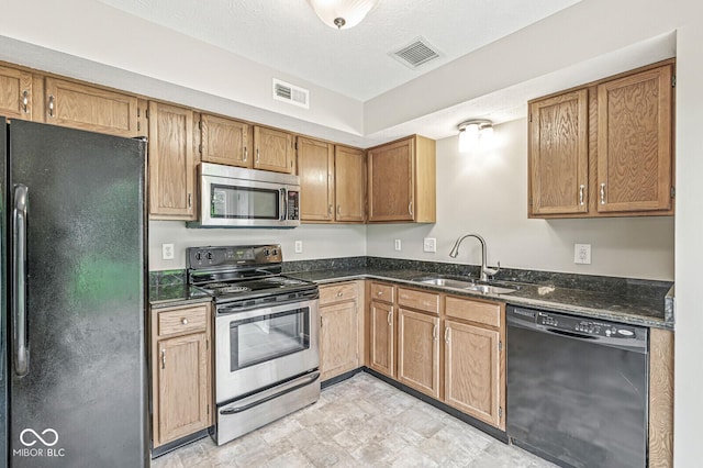 11072 Lake Run Dr, Fishers, IN 46038 - kitchen featuring black appliances, a sink, dark stone counters, and brown cabinets