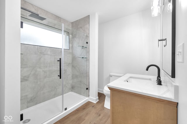 1027 Hosbrook St, Indianapolis, IN 46203 - bathroom with toilet, a stall shower, wood finished floors, vanity, and baseboards