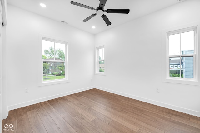 1027 Hosbrook St, Indianapolis, IN 46203 - spare room with baseboards, wood finished floors, a ceiling fan, and recessed lighting
