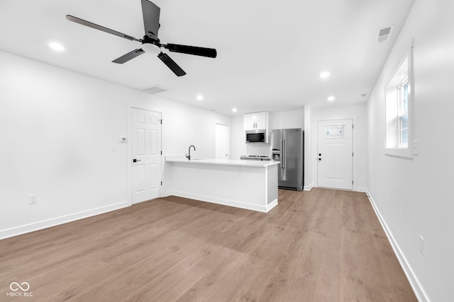 1027 Hosbrook St, Indianapolis, IN 46203 - kitchen featuring stainless steel appliances, light wood-style flooring, a ceiling fan, recessed lighting, and light countertops