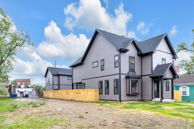 1027 Hosbrook St, Indianapolis, IN 46203 - view of property exterior with board and batten siding and a shingled roof
