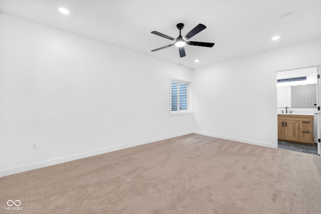 1027 Hosbrook St, Indianapolis, IN 46203 - unfurnished bedroom featuring light colored carpet, recessed lighting, baseboards, a sink, and connected bathroom