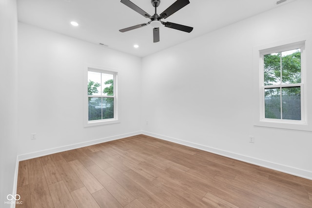 1027 Hosbrook St, Indianapolis, IN 46203 - unfurnished room with light wood-style floors, baseboards, a ceiling fan, and recessed lighting