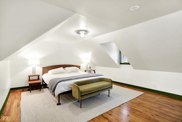 1725 W 53rd St, Indianapolis, IN 46228 - bedroom with hardwood / wood-style flooring, baseboards, and lofted ceiling