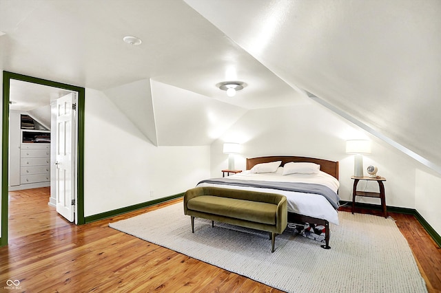 1725 W 53rd St, Indianapolis, IN 46228 - bedroom with hardwood / wood-style flooring, baseboards, lofted ceiling, and a spacious closet