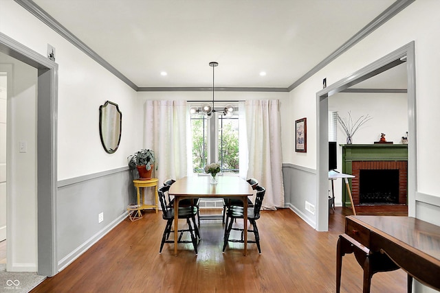 1725 W 53rd St, Indianapolis, IN 46228 - dining room with ornamental molding, wood finished floors, a chandelier, baseboards, and recessed lighting