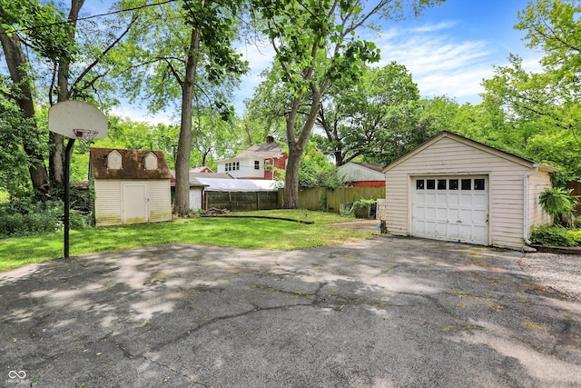 1725 W 53rd St, Indianapolis, IN 46228 - detached garage featuring asphalt driveway and a shed