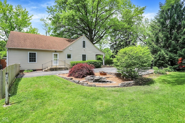 1725 W 53rd St, Indianapolis, IN 46228 - rear view of house with a shingled roof and a patio
