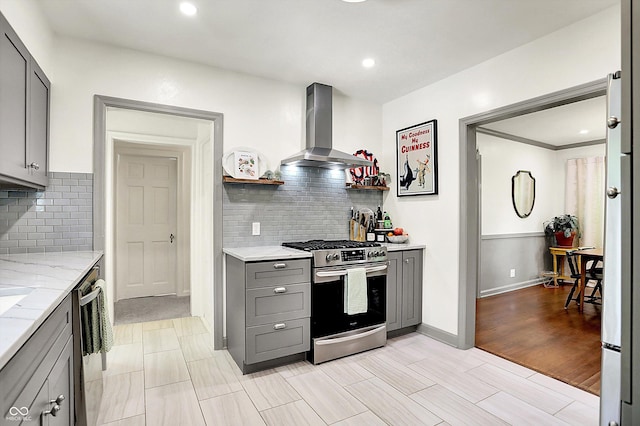 1725 W 53rd St, Indianapolis, IN 46228 - kitchen featuring extractor fan, stainless steel appliances, gray cabinets, light stone counters, and tasteful backsplash