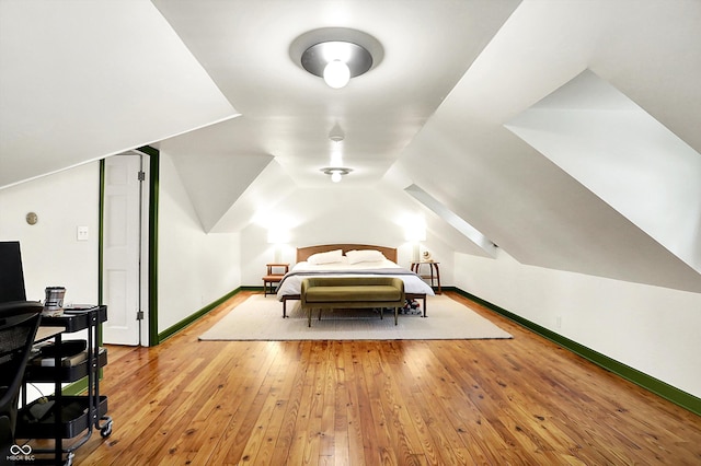1725 W 53rd St, Indianapolis, IN 46228 - bedroom featuring light wood-style floors, baseboards, and lofted ceiling