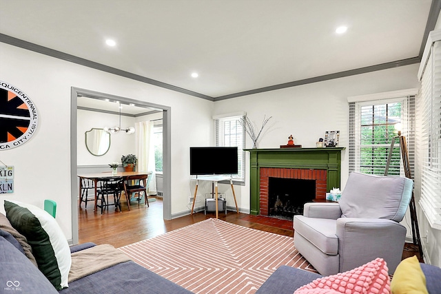 1725 W 53rd St, Indianapolis, IN 46228 - living area with crown molding, wood finished floors, a fireplace, healthy amount of natural light, and recessed lighting