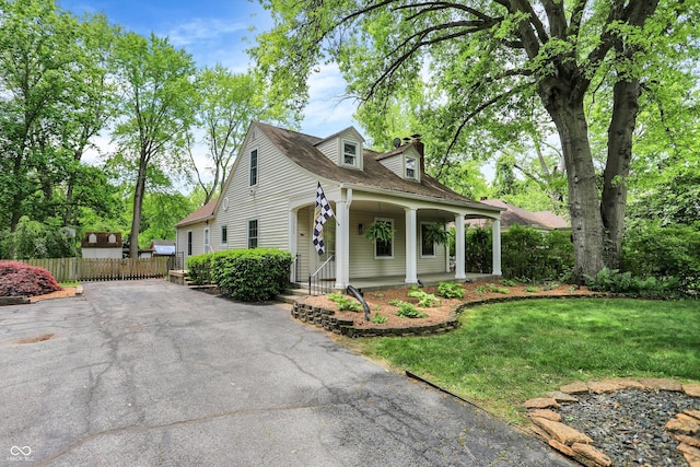 1725 W 53rd St, Indianapolis, IN 46228 - view of front of property featuring driveway, covered porch, and a chimney