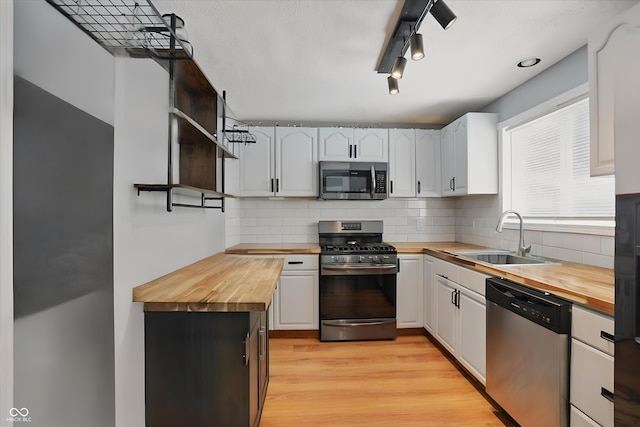 1240 Stringtown Pike, Cicero, IN 46034 - kitchen with wood counters, stainless steel appliances, open shelves, a sink, and decorative backsplash