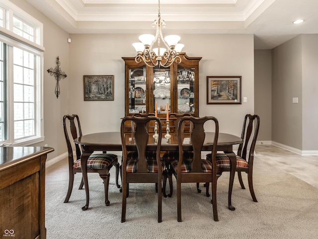 13069 Abraham Run, Carmel, IN 46033 - dining space with light carpet, a chandelier, a raised ceiling, crown molding, and baseboards