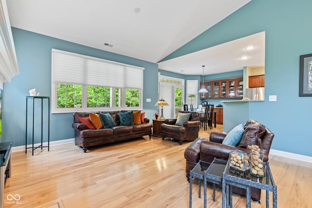 11510 Monon Farms Ln, Carmel, IN 46032 - living room featuring vaulted ceiling, light wood finished floors, and baseboards