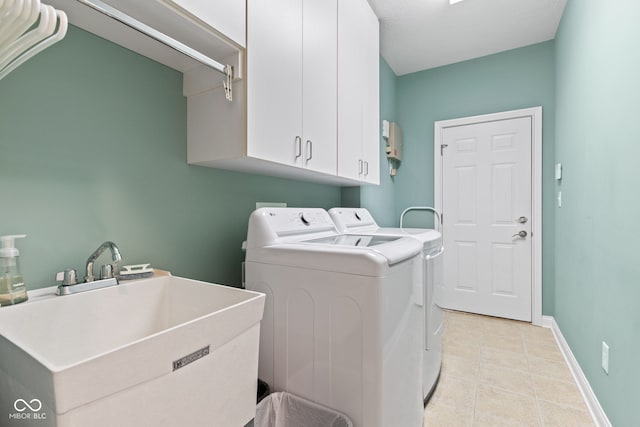 11510 Monon Farms Ln, Carmel, IN 46032 - laundry room with cabinet space, washer and dryer, light tile patterned floors, and baseboards