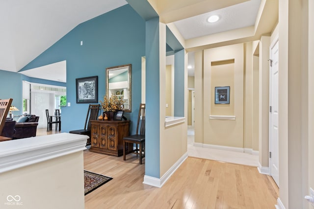 11510 Monon Farms Ln, Carmel, IN 46032 - corridor featuring light wood finished floors, vaulted ceiling, and baseboards