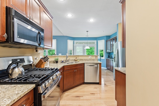 11510 Monon Farms Ln, Carmel, IN 46032 - kitchen with appliances with stainless steel finishes, a sink, a peninsula, light wood-style flooring, and recessed lighting