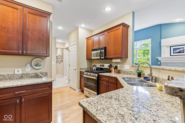 11510 Monon Farms Ln, Carmel, IN 46032 - kitchen with stainless steel appliances, a sink, light stone counters, light wood finished floors, and recessed lighting