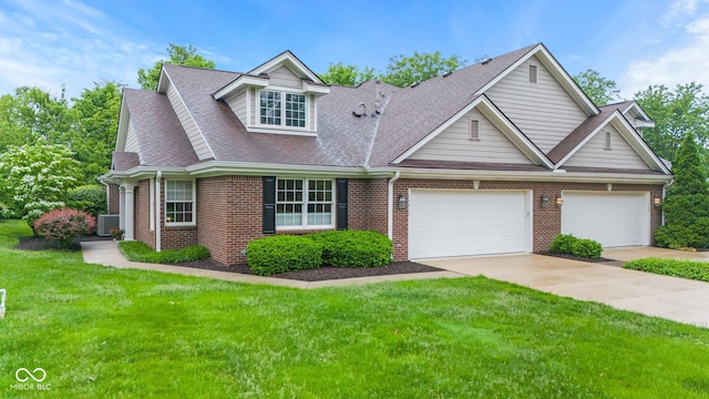 11510 Monon Farms Ln, Carmel, IN 46032 - view of front facade with brick siding, a front lawn, concrete driveway, a shingled roof, and an attached garage